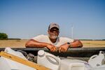 Anthony Bland, 58, leans over his truck in one of his fields in Sledge, Mississippi on Friday, April 17, 2026. When asked if he would continue farming, Bland referenced the definition of insanity as "doing the same thing expecting different results," adding, "with tariffs on top of the war, we know the results aren't going to get any better."