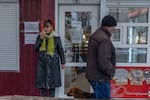 Svitlana Storozhko, owner of a small grocery, drinks coffee by the entrance of her shop in the center of Pokrovsk.  "We believe in God and in Ukraine's armed forces," she said, explaining her decision to stay in the besieged city.