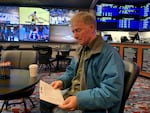 Football and basketball fan David Salisbury studying the daily odds at the Chinook Winds Casino sportsbook in Lincoln City, Oregon.