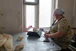 Ihor Yershov, a pastor, and his wife, Yevheniia Yershova (pictured above), run a community bakery in Kurakhove, near the war's front line, making and distributing free loaves of bread.