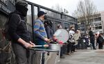 Drummers play in front of the Lane County Public Services Building, diagonally across the street from the federal building where most of the protestors gathered on Jan. 30.