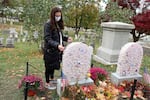 Katie Polfleit places an "I Voted" sticker on the grave of women's rights advocate Susan B. Anthony in Rochester, N.Y, in 2020.