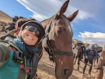 Brenda Johnson smiles and poses with a horse. The Oregon resident rode in the Gaucho Derby earlier this month.