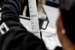 Students examine voting results from their sample ballots at Reading High School on Oct. 4, 2024 in Hillsdale, Mich.