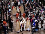King Charles III, front center, and Queen Camilla, middle center, walk in the Coronation Procession after his coronation ceremony at Westminster Abbey on Saturday.