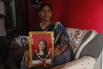 Neelum Chaturvedi holding a picture of her 18-year-old daughter Akanksha, who committed suicide in May, soon after authorities cancelled the results of a high-pressure medical exam Akanksha had taken, saying the results had been leaked.