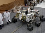 Engineers work on a model of the Mars rover Curiosity at the Spacecraft Assembly Facility at NASA's Jet Propulsion Laboratory in 2012.