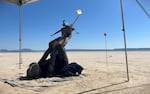 Alan Case uses both hands, and feet, to fire his homemade footbow in 2023. He travels to Oregon's Alvord Desert because it offers a wide open expanse to launch arrows more than a mile distance in his quest to break a world record.