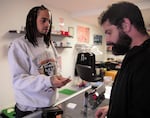 Rose City Vapors owner Marcus Nettles (left) works with customer Matt Menard at his shop in Northeast Portland. Nettles said Oregon's flavored vaping ban will cost him business to the internet.