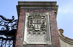 A relief sculpture rests on a gate to the entrance of Harvard University, in Cambridge, Mass., March 13, 2016.
