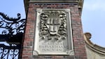 A relief sculpture rests on a gate to the entrance of Harvard University, in Cambridge, Mass., March 13, 2016.