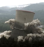 FILE - The cooling tower from the decommissioned Trojan nuclear power plant collapses in on itself in a cloud of dust and flying debris as it is imploded near Rainier, Ore., Sunday, May 21, 2006.