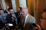 Reporters holding their smartphones surround Senator Tim Kaine as he speaks to them outside the Senate chamber on October 1.