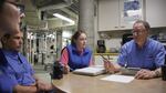 Biologist Jeff Christiansen (right) readies a team of Seattle Aquarium divers.