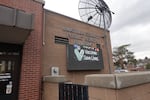 A squat brick building with an electronic sign that states, "Vaccines Save Lives."