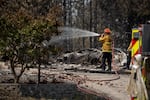 The Spokane Complex Fires have burned over 900 structures and over 10,000 acres as the fires continue for a sixth day on August 6, 2026 in one of the biggest fires in Washington State history. Firefighters visit burned homes to put out hot spots on the properties to prevent new blazes.