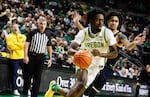 Oregon forward Dezdrick Lindsay (4) drives to the base against Michigan guard Elliot Cadeau (3) in the first half of an NCAA college basketball game in Eugene, Ore., Saturday, Jan. 17, 2026.