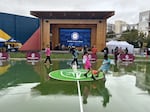 Children play "futsal" on a new pitch in downtown Renton, finished in time to celebrate the 2026 World Cup.