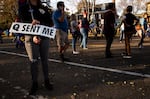 A woman holds a sign referencing the QAnon conspiracy on Nov. 7, 2020, in St. Paul, Minn. 