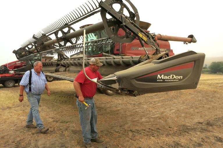 Chad Heimgartner (right) and his dad Lee Heimgartner farm about 4500 acres near Kendrick, Idaho. They're getting their combine ready to harvest chickpeas.