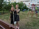 Evgeniya Kovalenko, 12, and her friend watch Ukrainian rockets streak past in the sky from the playground in front of their residential building on June 1 in Saltivka, a neighborhood in Kharkiv that has sustained severe shelling since the beginning of Russia’s full-scale invasion of Ukraine.