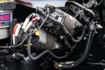 Two servo motors, redundant engine components unique to autonomous vehicles, are seen inside the engine of an autonomous semi-truck.