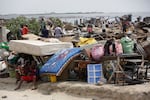 Residents salvage objects from houses demolished by government officials in Otodo-Gbame waterfront in Lagos Nigeria, Saturday, March 18, 2017.