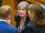 Oregon state Representative Lisa Reynolds, D-Beaverton, confers with colleagues on Feb. 5, 2024, during the opening of the legislative short session at the Oregon Capitol in Salem, Ore.