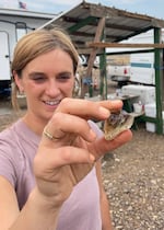 Oregon State University geologist Emily Cahoon holds an Oregon sunstone at the Double Eagle Mine near Plush, Ore.