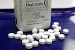 FILE - OxyContin pills arranged for a photo at a pharmacy, Feb. 19, 2013 in Montpelier, Vt.