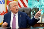 President Donald Trump point to a G20 Miami 2026 poster as he speaks in the Oval Office of the White House, Friday, Sept. 5, 2025, in Washington.
