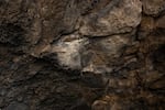 A long exposure image shows the interior wall of Boyd Cave in Bend, Ore., Nov. 10, 2020. A team of volunteers spent five days sand-blasting graffiti from the 1,600-foot lava tube.