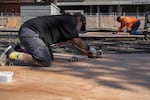 Art Rios and Charles Johnson build tent platforms for an emergency outdoor shelter for unhoused people of color on April 10, 2020 in Portland, Oregon. The shelters are necessary to help the most vulnerable unhoused people safely shelter-in-place during the coronavirus pandemic.