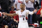 Portland Trail Blazers guard Damian Lillard pumps up the crowd. The Golden State Warriors defeated the Blazers 132-125 in Game 4 of the Western Conference Semifinals on Monday, May 9, 2016.