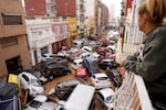 A woman looks from her balcony at vehicles stuck on the road during flooding in Valencia on Wednesday.