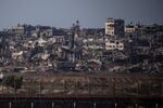 Destroyed buildings stand in the Gaza Strip, as seen from southern Israel, Monday, July 8, 2024. Israeli forces advanced deeper into the Gaza Strip's largest city in pursuit of militants who had regrouped there, sending thousands of Palestinians fleeing on Monday from an area ravaged in the early weeks of the nine-month-long war.