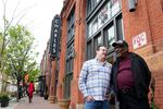 Record producer Zev Feldman (left) and John Fowler, a charter member of the Left Bank Jazz Society, meet outside the Charles Theater in downtown Baltimore. The building once hosted some of the best jazz musicians in the country.