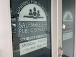Salem-Keizer Public Schools' logo is on two doors of a building. It reads: Learning for a lifetime. Salem-Keizer Public Schools. Student services. Monday through Friday. 7:30 a.m. to 4:30 p.m.