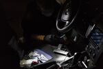 Officer Patrick Murphy swabs a handgun which PPB officers found in a car with three individuals in front of a high school homecoming football game in Northeast Portland on September 21, 2018 in Portland, Oregon. 