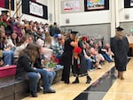 Perrydale teacher, community liaison, and student success advisor Margaret White hugs a graduate at the high school’s graduation ceremony on June 6, 2026 in Amity, Ore. Perrydale is one of 19 Oregon school districts with a 100% graduation rate in 2025.