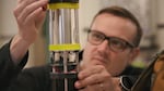 In this video still, Oregon State University geologist Jeff Beeson prepares a bottom pressure recorder for deployment to the ocean floor in June 2022.
