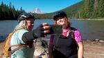 Marley Blonsky, left, and Kailey Kornhauser of All Bodies on Bikes take a selfie at Frog Lake near Mount Hood. The popularity of their group has made them social media influencers.