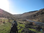 Hiking to a fishing spot on the Deschutes River.