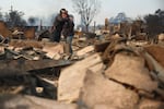 People embrace as they inspect a family member's property that was destroyed by the fires in Altadena, Calif., on Jan. 9, 2025.