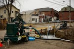 Water is pumped into a creek for aeration in East Palestine, Ohio, after a train derailment released toxic chemicals.