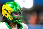 FILE - Oregon quarterback Dante Moore warms up before the Peach Bowl NCAA college football playoff semifinal against Indiana, Jan. 9, 2026, in Atlanta.