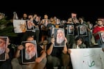 Demonstrators hold pictures of Hassan Nasrallah, late leader of the Lebanese group Hezbollah, during a protest vigil in the southern Lebanese city of Sidon on Saturday.