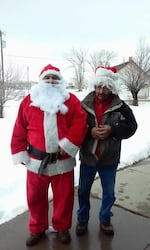 Undated photo of Kirby Paradise, left, dressing up as Santa Claus during Christmastime.