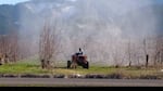 Cloud of pesticides surround pear orchard worker in the Rogue Valley. Farmworker advocates say this kind of spraying can cause pesticide drift. 