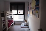 Aurora takes a virtual Spanish lesson in the bedroom she shares with her brother.